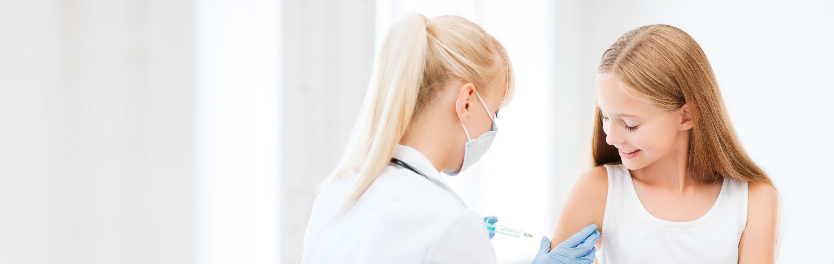 Doctor vaccinating a teenage girl