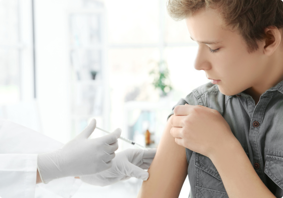 Doctor vaccinating a teenage boy